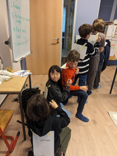Learners are turning each other into superheroes by writing strengths on one another’s capes. Photo by Carmelo Zamora at REAL School Budapest.