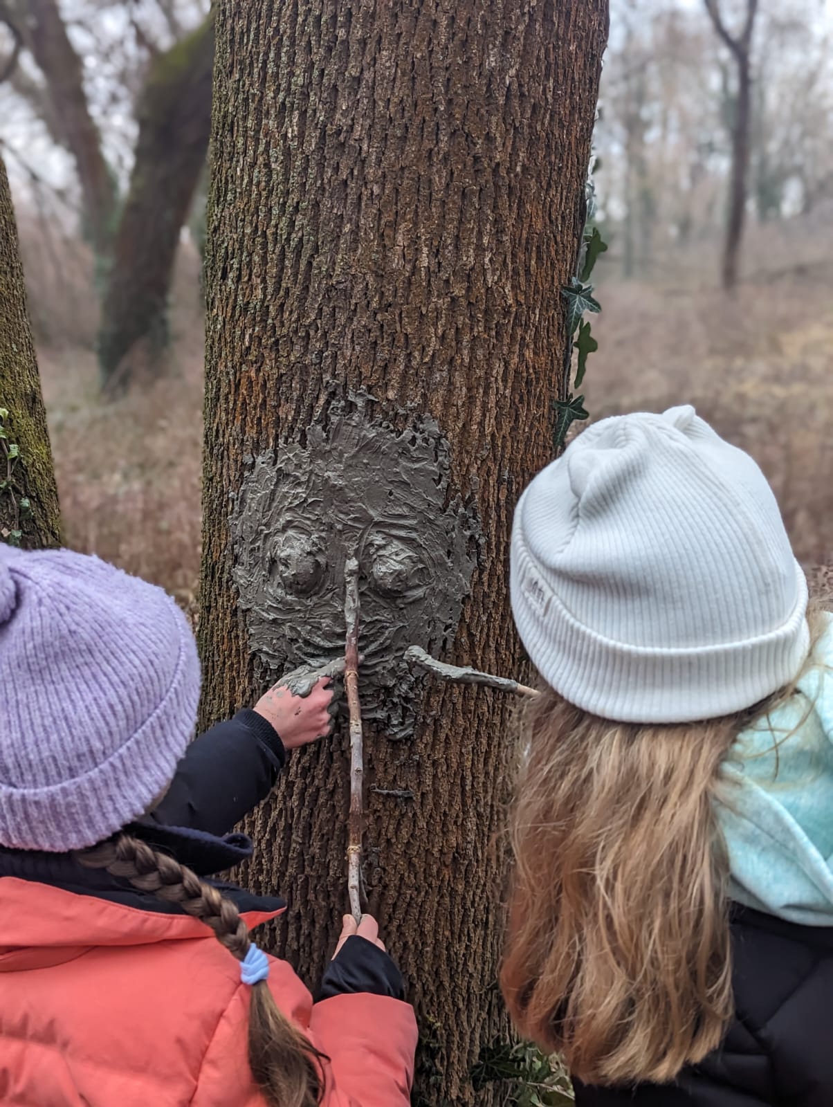 Learners creating and giving shape to a tree face with natural clay. Photo by Carmelo Zamora, REAL School Budapest