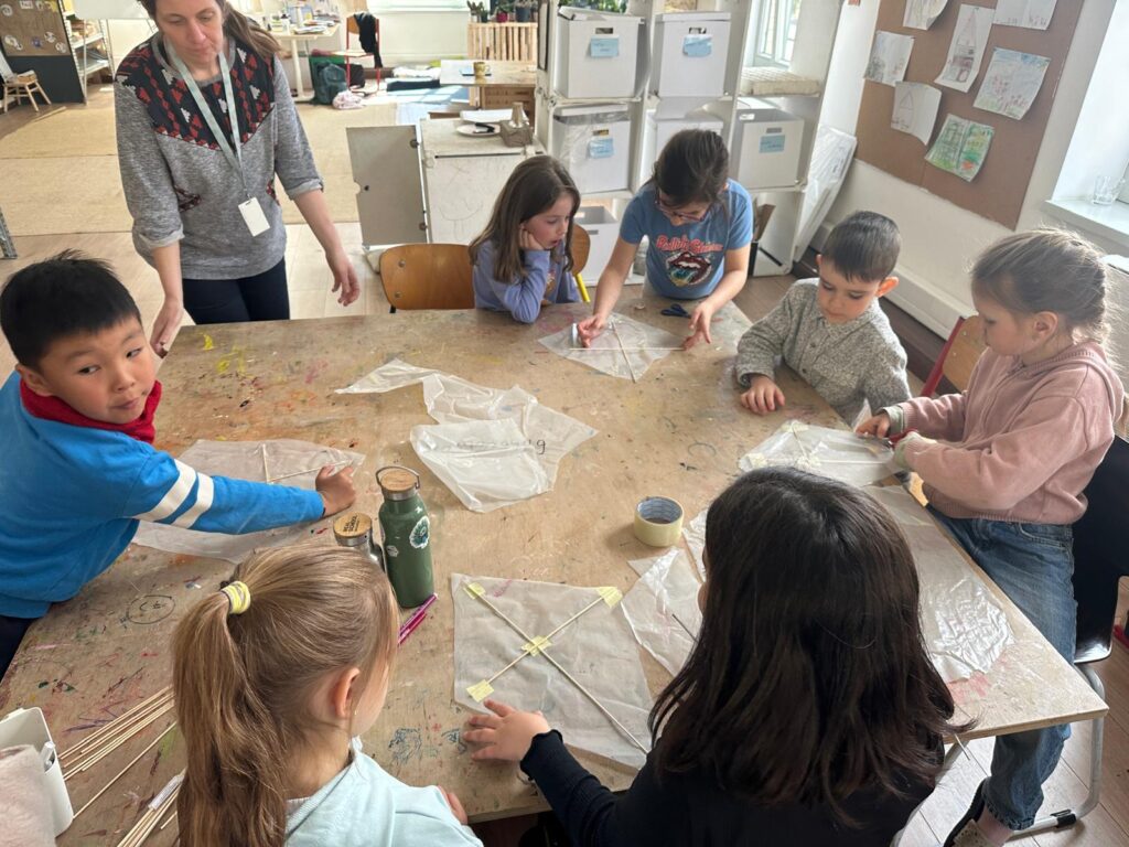 In the making! Learners using recycled plastic and wooden sticks to create their kites. Photo by Sierra de Lew, REAL School Budapest
