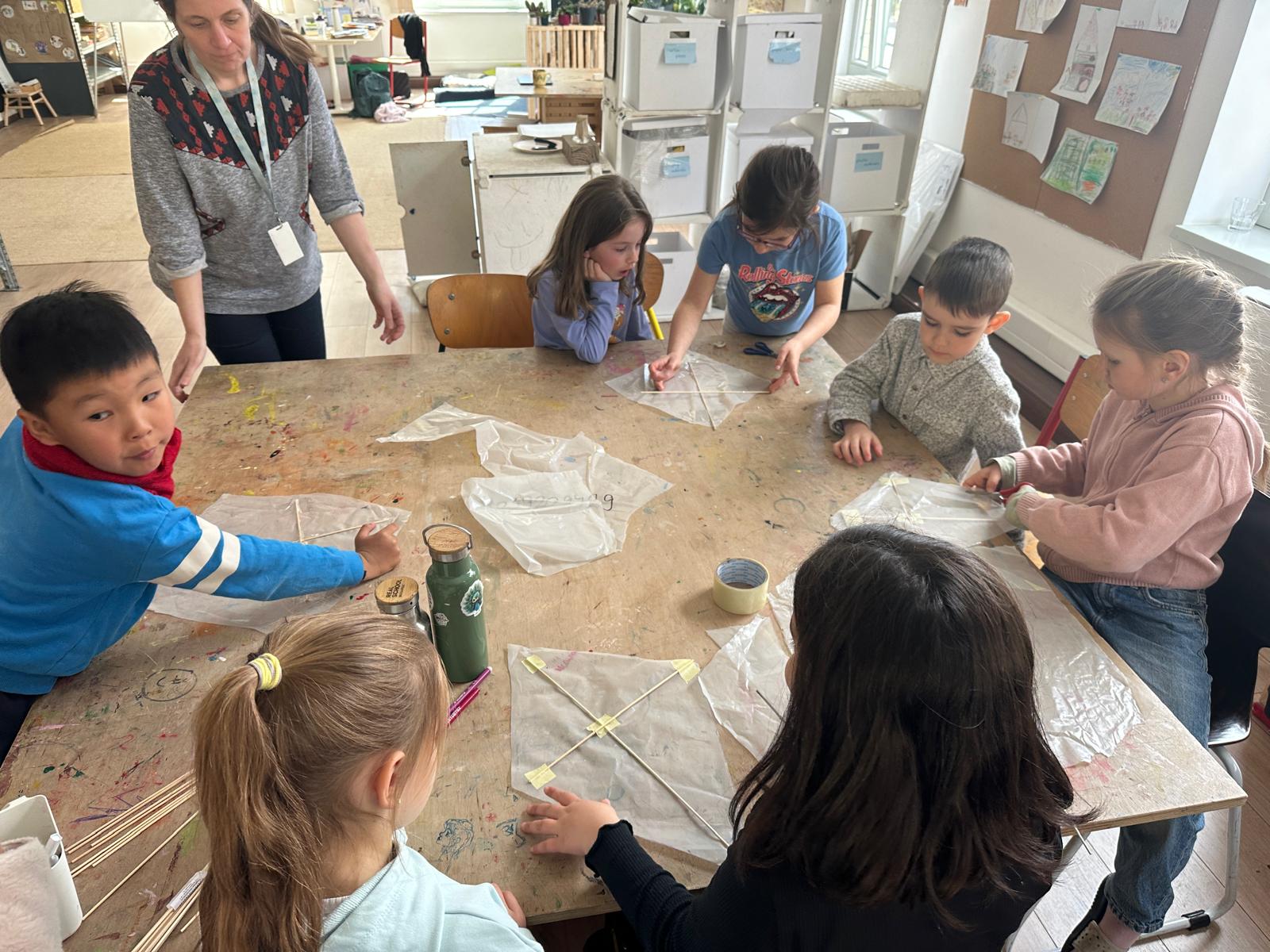 In the making! Learners using recycled plastic and wooden sticks to create their kites. Photo by Sierra de Lew, REAL School Budapest 